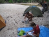 Camping on the Pascoe River. Mark is cooking up his specialty damper. The local road crew told us of this spot a bit down from the crossing.